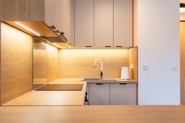 Sleek kitchen interior with wooden cabinets and LED lighting