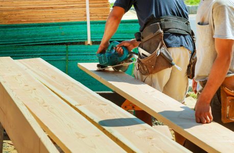 Wood cutting with circular saw male worker or handy man with power tools