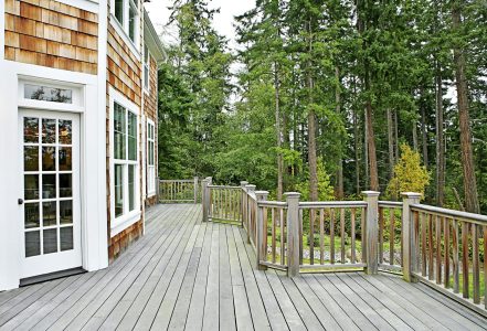 Wooden deck on house near forest